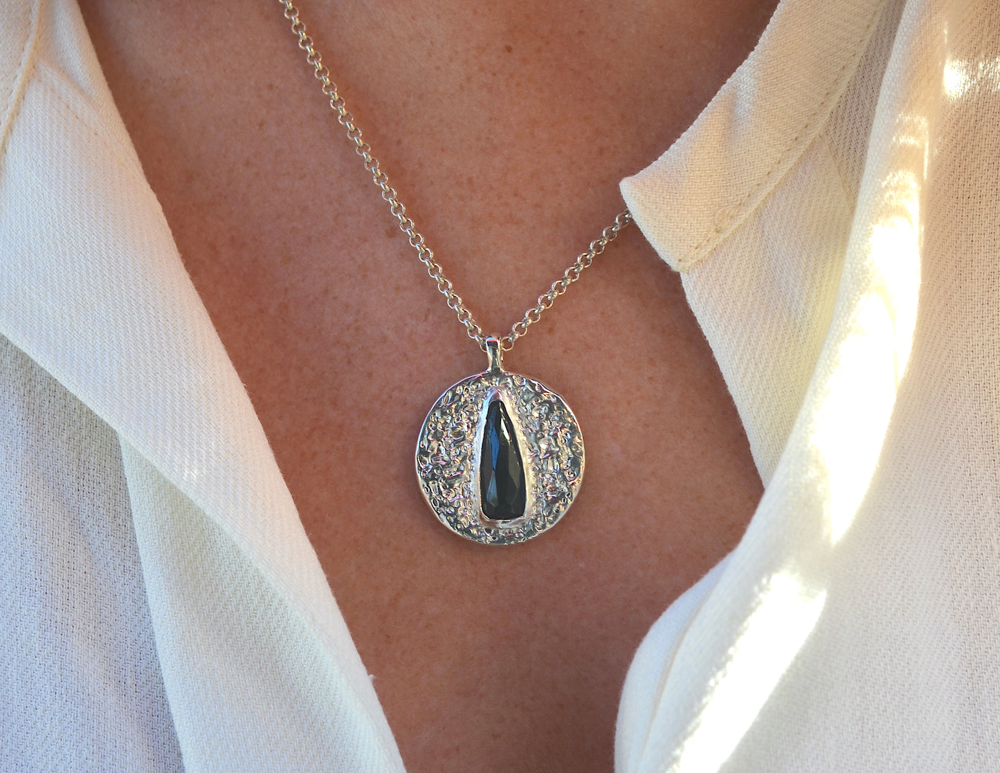 dark blue elongated pear medallion