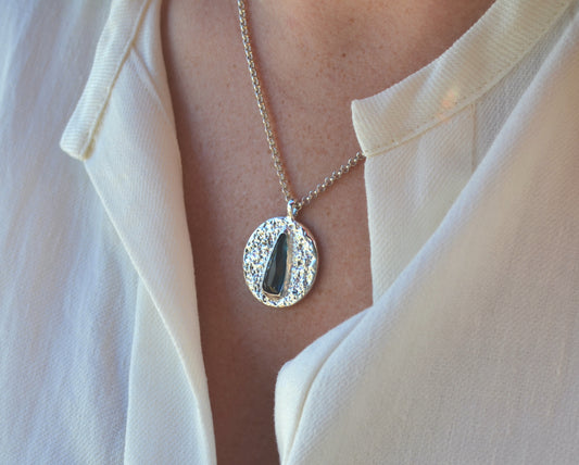 dark blue elongated pear medallion